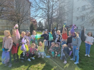 Uczniowie klas 1 podczas sprzątania terenów w pobliżu szkoły